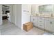 Bright bathroom features a double vanity and a lighted mirror with walk-in shower at 27709 Robin Roost Ln, Wesley Chapel, FL 33544
