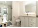 Bright bathroom with a glass enclosed shower and white vanity with an illuminated mirror at 27709 Robin Roost Ln, Wesley Chapel, FL 33544