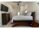 Bedroom featuring a king bed, ceiling fan, and tiled flooring at 27709 Robin Roost Ln, Wesley Chapel, FL 33544