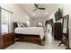 Bedroom featuring a king bed, ceiling fan, and tiled flooring at 27709 Robin Roost Ln, Wesley Chapel, FL 33544