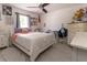 Bright bedroom featuring a comfortable bed, natural light, and ceiling fan at 27709 Robin Roost Ln, Wesley Chapel, FL 33544