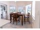 Cozy breakfast nook with wood table, chairs, and natural light from surrounding windows at 27709 Robin Roost Ln, Wesley Chapel, FL 33544
