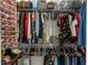 Walk-in closet with hanging clothes, handbags and shoe storage at 27709 Robin Roost Ln, Wesley Chapel, FL 33544
