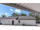 Exterior side view with a garage connected to the house, including the carport roof in the view at 27709 Robin Roost Ln, Wesley Chapel, FL 33544