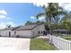 Rear exterior view of the home showcasing a screened pool area and expansive yard with lots of potential at 27709 Robin Roost Ln, Wesley Chapel, FL 33544