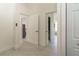Hallway featuring tiled flooring and white doors at 27709 Robin Roost Ln, Wesley Chapel, FL 33544