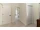 Hallway featuring white doors and tiled flooring at 27709 Robin Roost Ln, Wesley Chapel, FL 33544