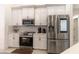 Modern kitchen featuring stainless steel appliances and white cabinetry at 27709 Robin Roost Ln, Wesley Chapel, FL 33544