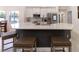 Modern kitchen featuring a large island with seating, stainless steel appliances, and sleek white cabinetry at 27709 Robin Roost Ln, Wesley Chapel, FL 33544