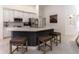 Kitchen with central island, modern appliances, white cabinetry, and tiled flooring at 27709 Robin Roost Ln, Wesley Chapel, FL 33544