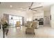 Open concept living room featuring sliding glass doors and clear views of the kitchen and dining room at 27709 Robin Roost Ln, Wesley Chapel, FL 33544