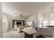 Open concept living room with a stylish entertainment center and a breakfast bar with seating overlooking the dining room at 27709 Robin Roost Ln, Wesley Chapel, FL 33544