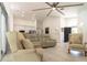 Open concept living room with clear views of the kitchen and front door at 27709 Robin Roost Ln, Wesley Chapel, FL 33544