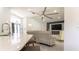 Bright living room with a modern ceiling fan, stylish entertainment center and breakfast bar overlooking the front door at 27709 Robin Roost Ln, Wesley Chapel, FL 33544