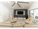 Modern living room featuring stylish decor, tile floors, and a view of the inviting pool at 27709 Robin Roost Ln, Wesley Chapel, FL 33544