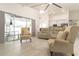Bright living room featuring sliding glass doors and clear views of the kitchen at 27709 Robin Roost Ln, Wesley Chapel, FL 33544