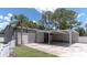 The large outbuilding and white fence offer ample parking and storage options at 27709 Robin Roost Ln, Wesley Chapel, FL 33544