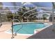 Relax in the screened-in pool, surrounded by lush landscaping, for a private escape at 27709 Robin Roost Ln, Wesley Chapel, FL 33544