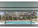 Screened-in pool with lush landscaping offers a private and serene backyard oasis at 27709 Robin Roost Ln, Wesley Chapel, FL 33544