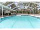 Refreshing screened-in pool offers the perfect spot for a cool dip and outdoor enjoyment at 27709 Robin Roost Ln, Wesley Chapel, FL 33544