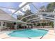 Enjoy the screened-in pool and adjacent patio, perfect for outdoor entertaining and relaxation at 27709 Robin Roost Ln, Wesley Chapel, FL 33544