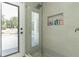 Modern shower with glass enclosure and built in shower product storage niche at 27709 Robin Roost Ln, Wesley Chapel, FL 33544