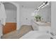 Bright bathroom featuring a double vanity and soaking tub, with a view to the connected bedroom at 3002 Savannah Oaks Cir, Tarpon Springs, FL 34688