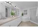 Bright bathroom with double vanity, large mirror, garden tub, and glass-enclosed shower at 3002 Savannah Oaks Cir, Tarpon Springs, FL 34688