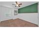 This bedroom features a ceiling fan, fresh paint, and a window for natural light at 3002 Savannah Oaks Cir, Tarpon Springs, FL 34688
