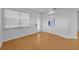 Clean bedroom featuring light wood flooring, neutral walls, recessed lighting, arched alcove, and bright window at 3002 Savannah Oaks Cir, Tarpon Springs, FL 34688