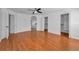 Spacious bedroom includes wood-look flooring, an arched doorway, and dual walk-in closets at 3002 Savannah Oaks Cir, Tarpon Springs, FL 34688