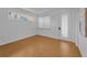 Clean bedroom featuring light wood flooring, neutral walls, recessed lighting, and bright window at 3002 Savannah Oaks Cir, Tarpon Springs, FL 34688