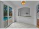 Breakfast nook with a breakfast bar looking through a passthrough window to the pool at 3002 Savannah Oaks Cir, Tarpon Springs, FL 34688