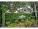 Meadow Ridge community sign surrounded by lush greenery and trees, providing a welcoming entrance to the neighborhood at 3002 Savannah Oaks Cir, Tarpon Springs, FL 34688