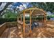 Inviting outdoor deck with seating is the perfect place for relaxation and entertainment at 3002 Savannah Oaks Cir, Tarpon Springs, FL 34688