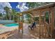 Picturesque deck with seating provides the perfect spot to unwind and enjoy the lush scenery at 3002 Savannah Oaks Cir, Tarpon Springs, FL 34688