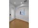 Minimalist entryway with light wood flooring, neutral paint, recessed lighting, artwork and sidelight window at 3002 Savannah Oaks Cir, Tarpon Springs, FL 34688