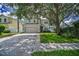 Charming two-story home with a two-car garage, mature trees, and a well-manicured lawn in a serene setting at 3002 Savannah Oaks Cir, Tarpon Springs, FL 34688
