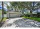 Exterior shot of a well maintained two story home with a neutral color scheme, two car garage and trimmed windows at 3002 Savannah Oaks Cir, Tarpon Springs, FL 34688
