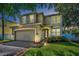 Exterior shot of a well maintained two story home with a neutral color scheme, two car garage and trimmed windows at 3002 Savannah Oaks Cir, Tarpon Springs, FL 34688