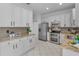 Spacious kitchen with stainless steel appliances, granite countertops, and white cabinetry at 3002 Savannah Oaks Cir, Tarpon Springs, FL 34688