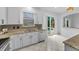 Kitchen with granite countertops, stainless steel appliances and view of pool and lanai at 3002 Savannah Oaks Cir, Tarpon Springs, FL 34688