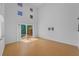 Bright living room with wood floors, high ceilings, clerestory windows and a sliding glass door to the pool at 3002 Savannah Oaks Cir, Tarpon Springs, FL 34688