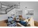 Staged living room showcases an open layout and staircase near kitchen, dining, and cozy seating arrangements at 3002 Savannah Oaks Cir, Tarpon Springs, FL 34688