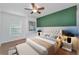 The primary bedroom includes a neutral color palette, ceiling fan and bedside table at 3002 Savannah Oaks Cir, Tarpon Springs, FL 34688