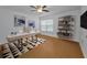 Well-lit home office with sleek desk, modern shelving, and wood flooring at 3002 Savannah Oaks Cir, Tarpon Springs, FL 34688