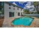 Backyard view showcases the sparkling pool, paver patio, and backyard, perfect for outdoor entertaining at 3002 Savannah Oaks Cir, Tarpon Springs, FL 34688