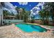 Relax in this beautiful pool surrounded by lush tropical landscaping at 3002 Savannah Oaks Cir, Tarpon Springs, FL 34688