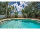Cool off in this refreshing pool with patio surround and privacy landscaping at 3002 Savannah Oaks Cir, Tarpon Springs, FL 34688