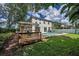 The backyard shows a deck, pool, and well-maintained lawn, making it an ideal spot for outdoor enjoyment at 3002 Savannah Oaks Cir, Tarpon Springs, FL 34688